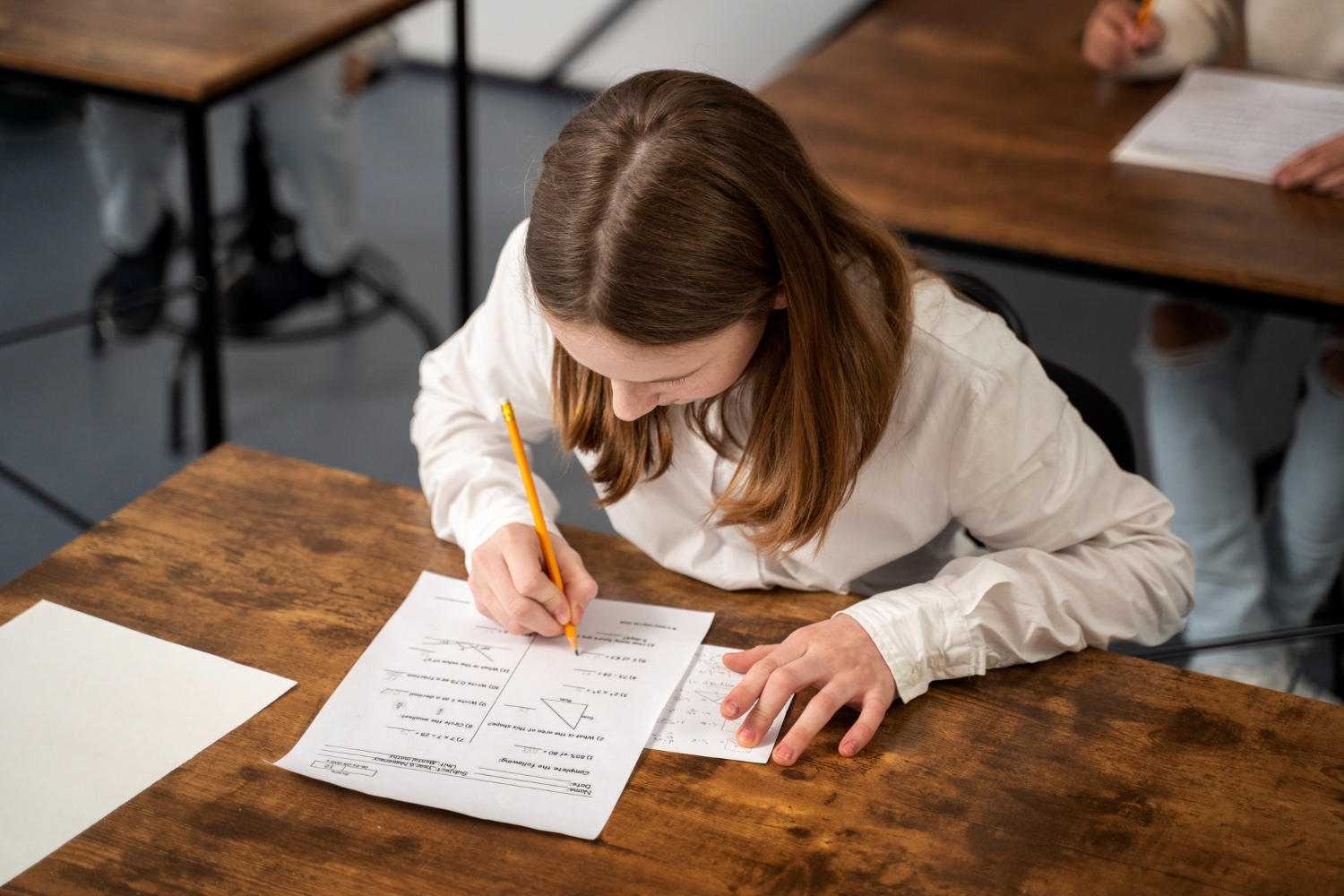 Student studying and solving exam paper – JEE & NEET preparation routine